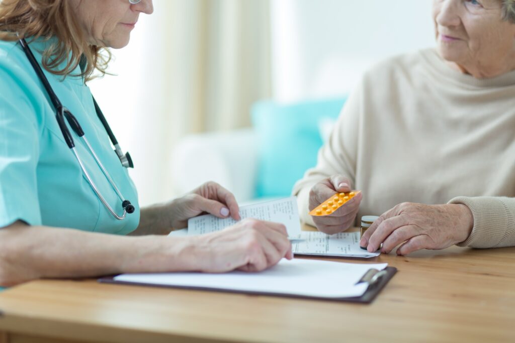 Female doctor prescribing medicament for senior woman